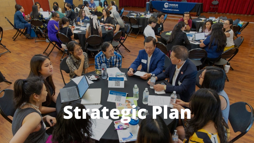 Strategic Plan People sitting at roundtables during a conference with text: DEI Strategic Plan