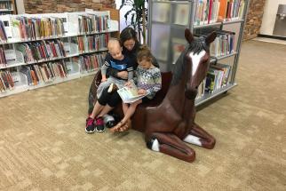 family reads together in library