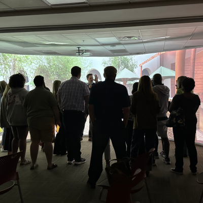 Group of people in front of large screen at immersion lab