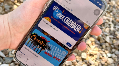 Cell phone with two Choose Chandler experiences on display