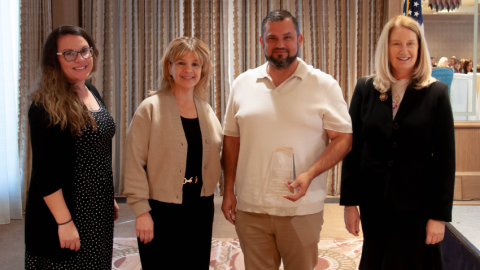 Korenna Tessier-Pothier; Regan Tillar; Jairo Garcia; Chief Justice Ann A. Scott Timmer with the award at the 2025 Court Leadership Conference. Not pictured: Presiding Judge Alicia Skupin and Ken Kung.