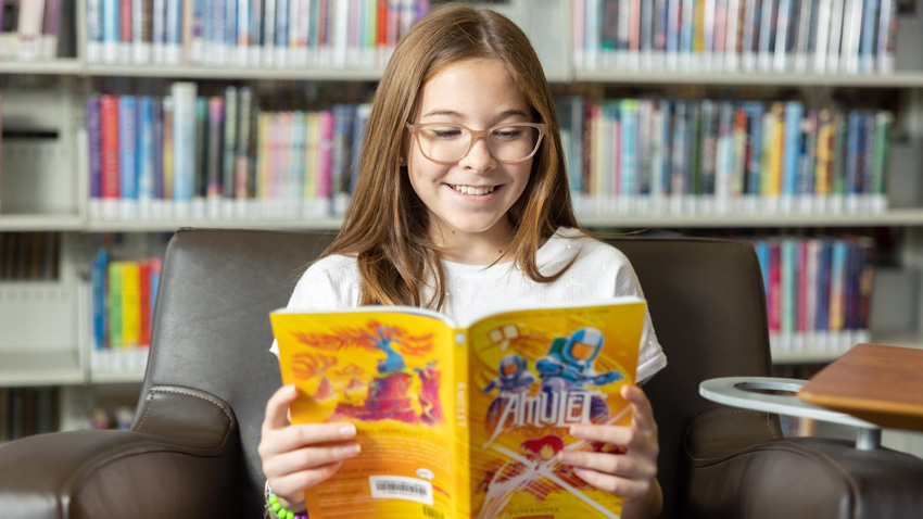 Youth reading book at the Chandler Library