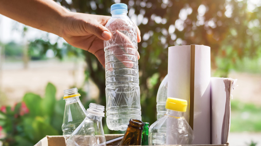 Water bottle being added to recycling box