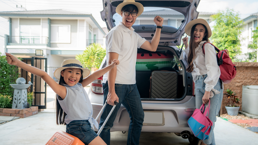 Family unpacking car for vacation