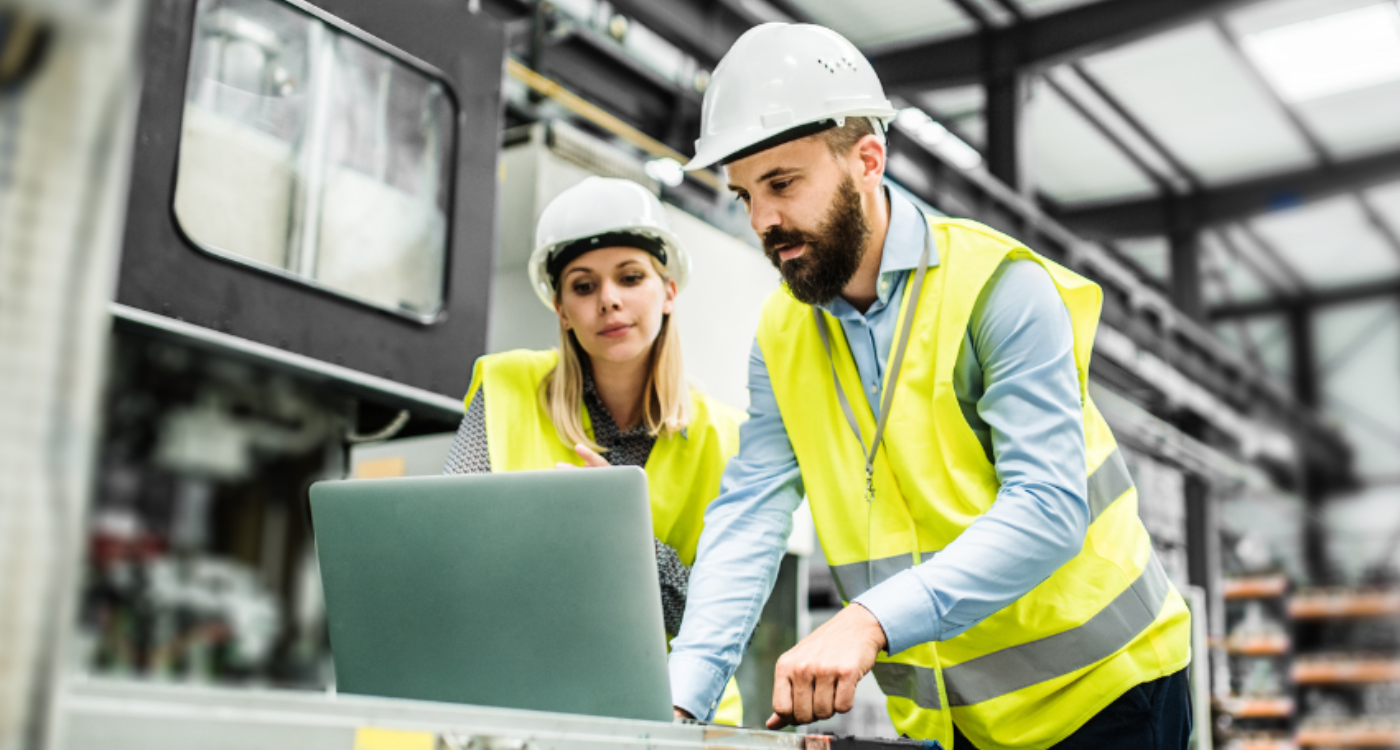 Two engineers in protective gear at a construction job site