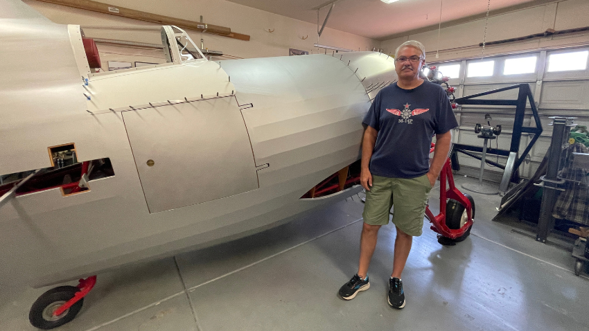 Mac Transtrum staning next to the Gee Bee he built