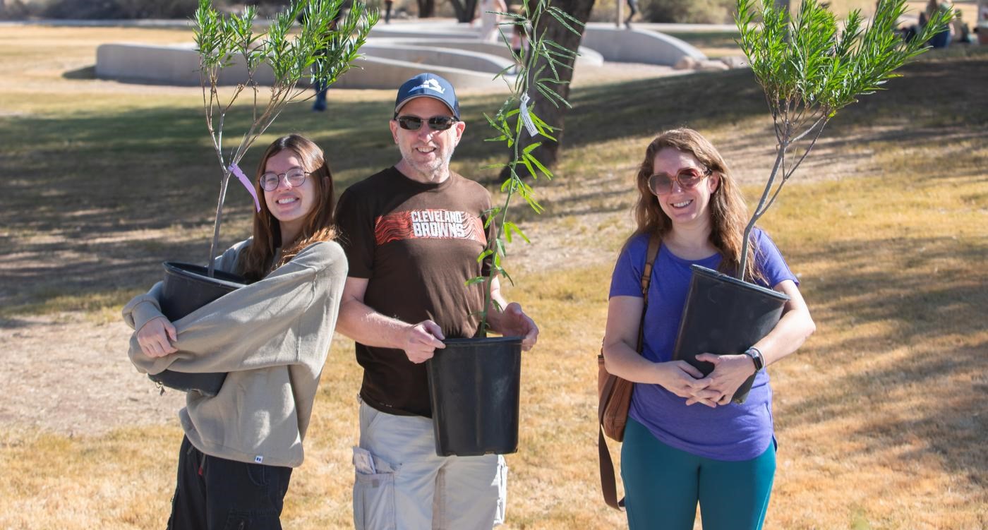 volunteers holding trees