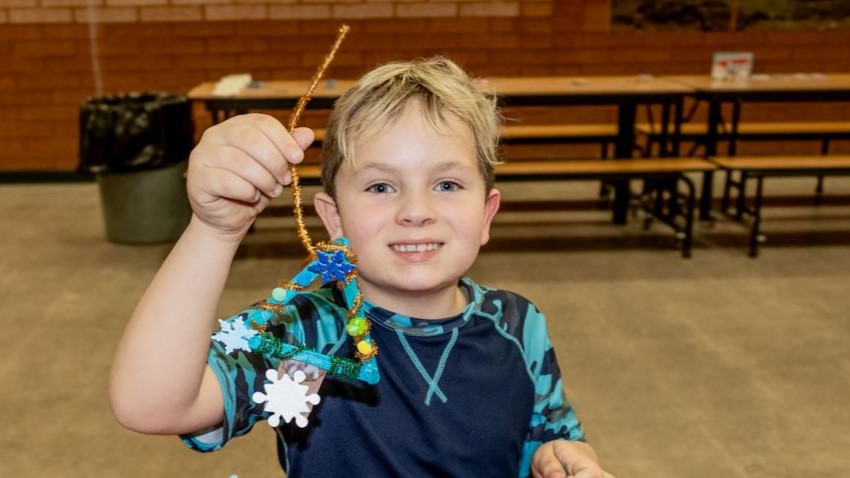 community nights boy making holiday ornament