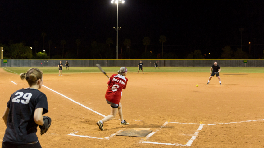 women hitting a softball