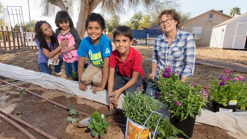 Children assisting with planting a neighborhood garden