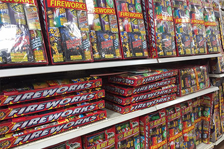 Shelf display of sparklers and novelty fireworks for sale.