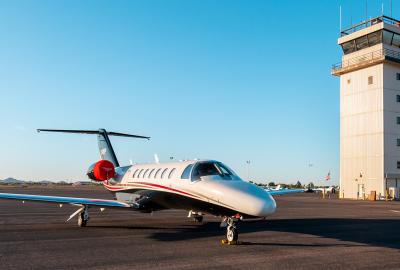 Plane and airport control tower in the background