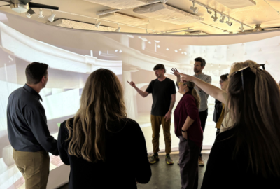 Photo of immersive experience lab - people looking at large curved screen