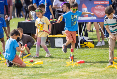 Photo of kids jumping on rocket launchers at the Northrop Grumman booth