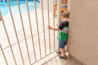 boy at pool gate