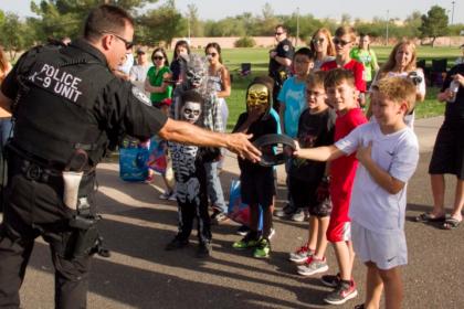 Police officer interacting with a group of kids during a G.A.I.N. event