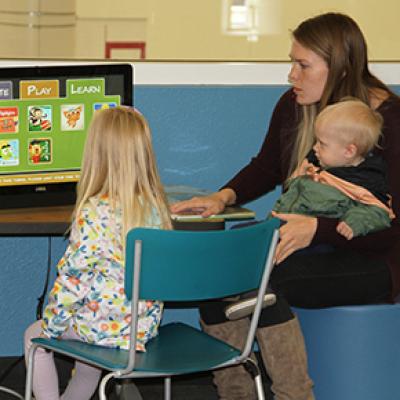 Mom with kids looking at a computer