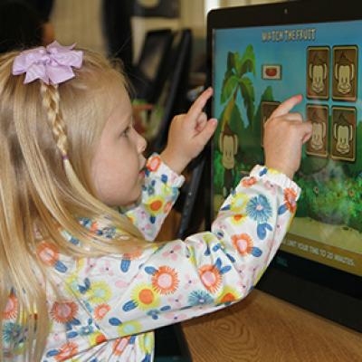 Young girl using a text screen computer