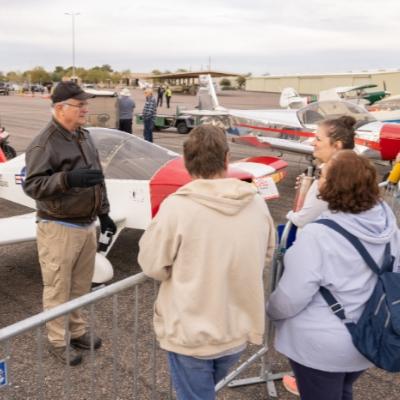 a pilot talking about his aircraft to a small group of people