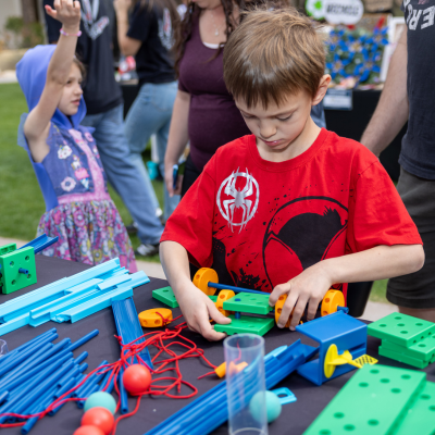 Young boy playing with Legos and other building toys