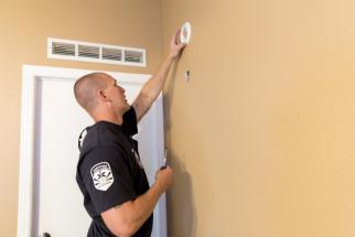 Chandler Fire testing a resident's smoke alarm Chandler Fire testing a resident's smoke alarm