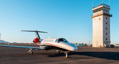 Plane and airport control tower in the background