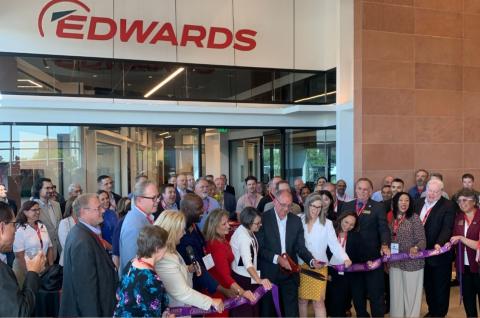 Crowd of people including Chandler Mayor Kevin Hartke and Gov. Katie Hobbs cutting a ribbon at Edwards