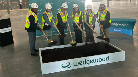 Wedgewood executives and Mayor Hartke at groundbreaking with shovels in hand wearing bright yellow vests