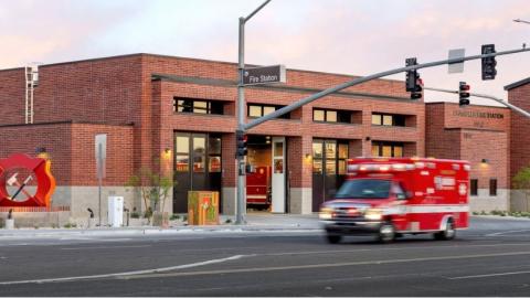 blurred image of an ambulance driving past a Chandler fire station