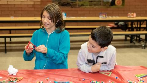 Two youth participating in arts and crafts during a Community Nights event