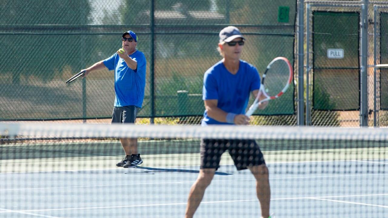 two men playing tennis