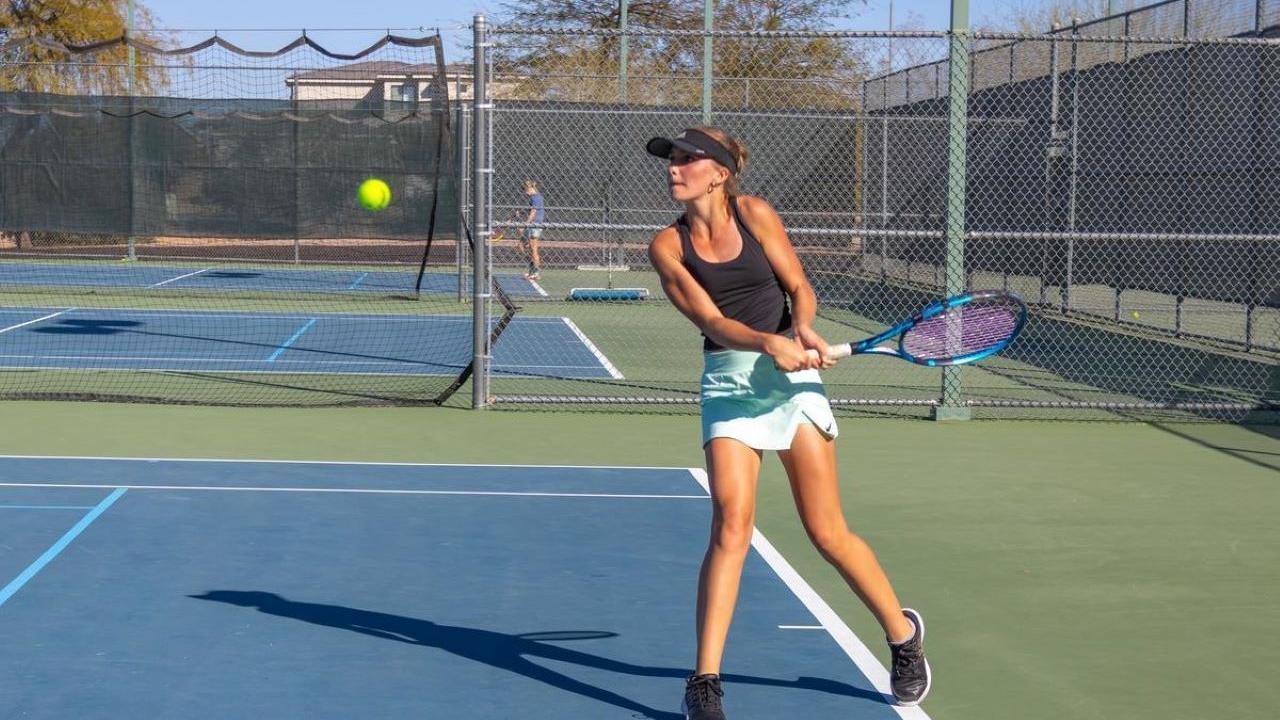 teen playing tennis