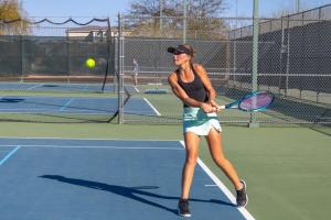 teen playing tennis