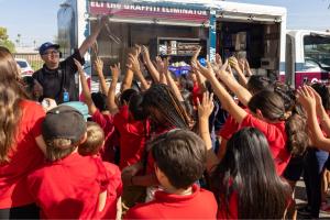 kids surrounding the graffiti truck